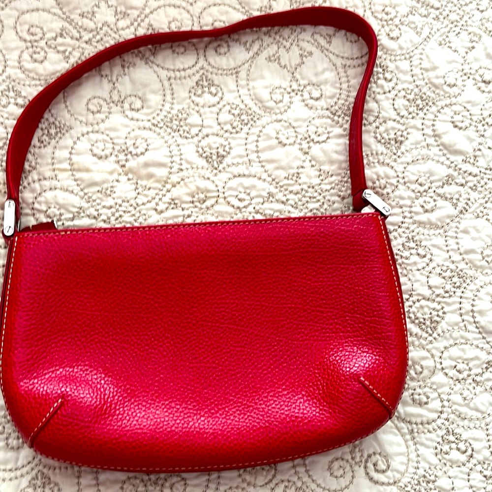 Red leather handbag. Tusk